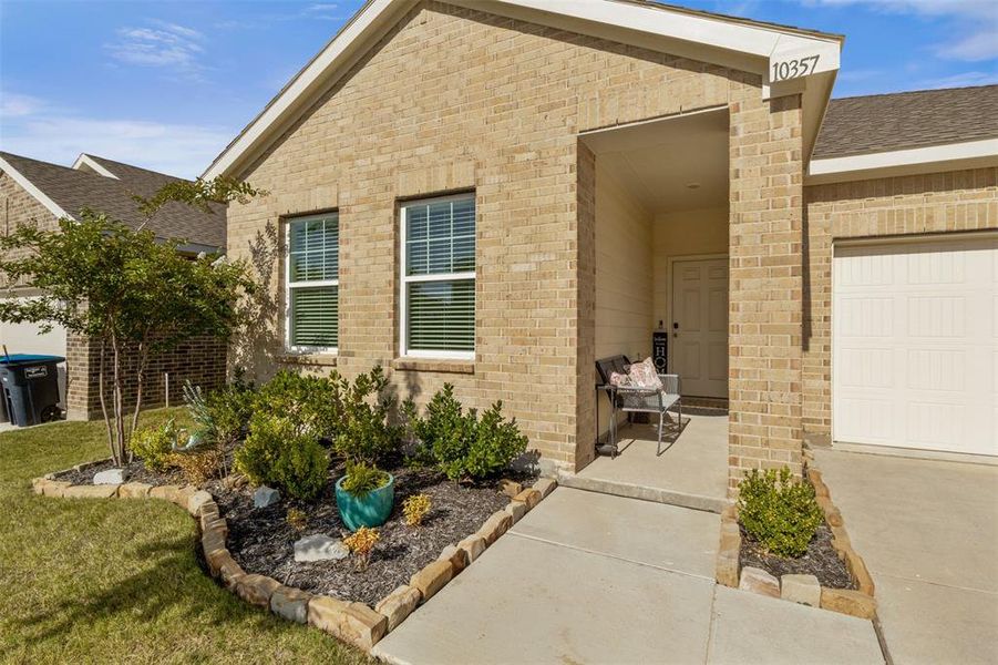 Property entrance with brick siding and a shingled roof