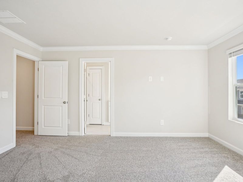 The primary bedroom connects conveniently to a private ensuite.