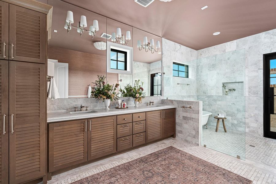 Full bathroom with double vanity, a walk in shower, tile walls, recessed lighting, and a soaking tub