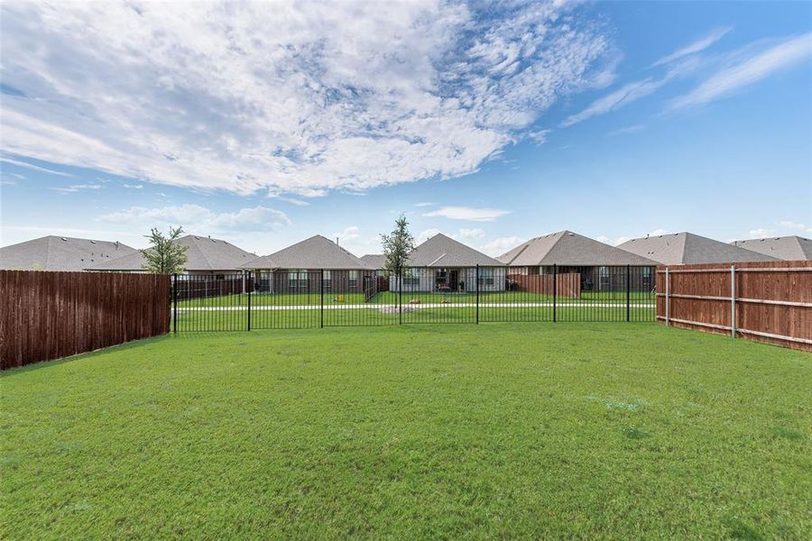 Fenced backyard with a residential view