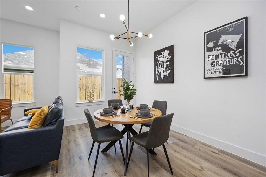 Enjoy breakfast or dinner in this dining space with access to the patio and green space.