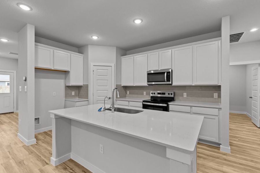 A kitchen with white cabinets. A kitchen with white cabinets.