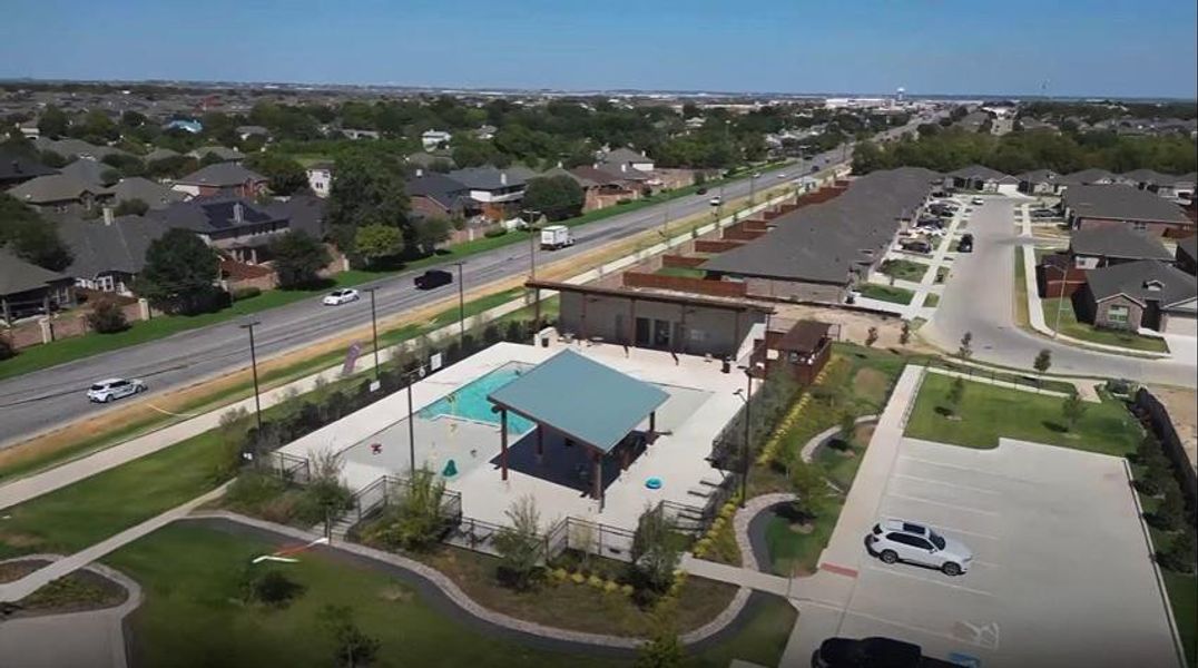 View of property location with a pool and nearby suburban area