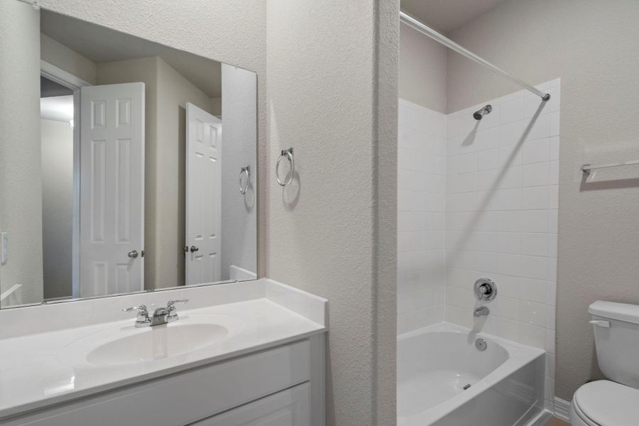 The secondary bath features tile flooring, white cabinetry and light countertops and a shower/tub combo. Perfect for accommodating any visiting family and friends. The secondary bath features tile flooring, white cabinetry and light countertops and a shower/tub combo. Perfect for accommodating any visiting family and friends.