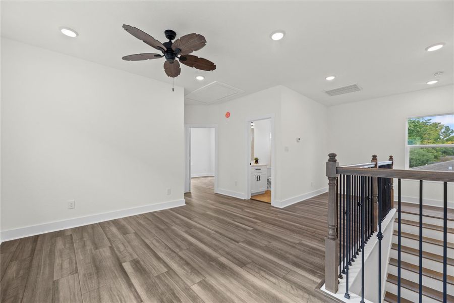 Designed for versatility, this upstairs bonus area is a great spot for a game table or cozy lounge setup. The sleek vinyl flooring adds warmth and durability, while the neutral tones make decorating easy. Designed for versatility, this upstairs bonus area is a great spot for a game table or cozy lounge setup. The sleek vinyl flooring adds warmth and durability, while the neutral tones make decorating easy.