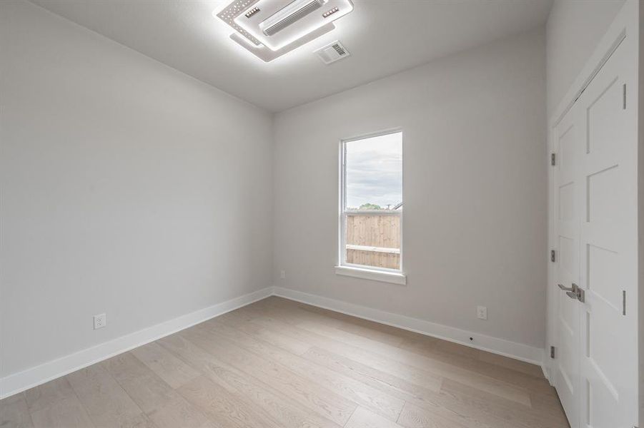 Empty room featuring light wood-style flooring and baseboards