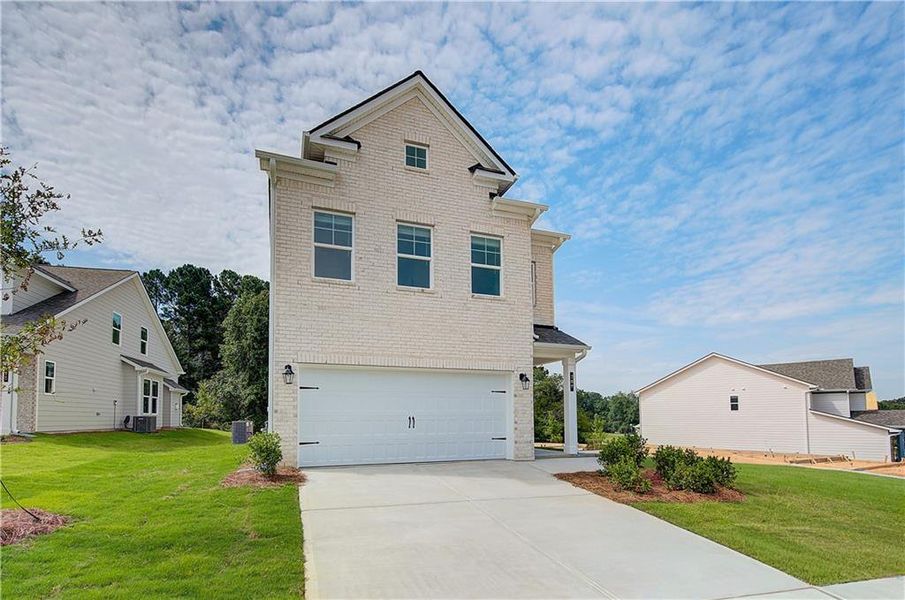 Front exterior of a new home in Abbotts Crossing, Conyers, GA, highlighting curb appeal (Image 16).