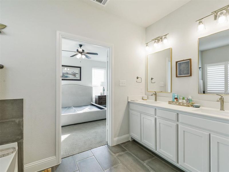 Bathroom featuring ceiling fan, vanity, and tile patterned floors