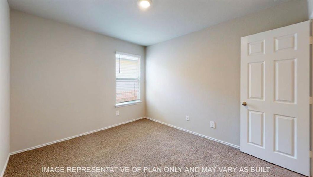 Carpeted room with neutral wall tones and a single window featuring blinds