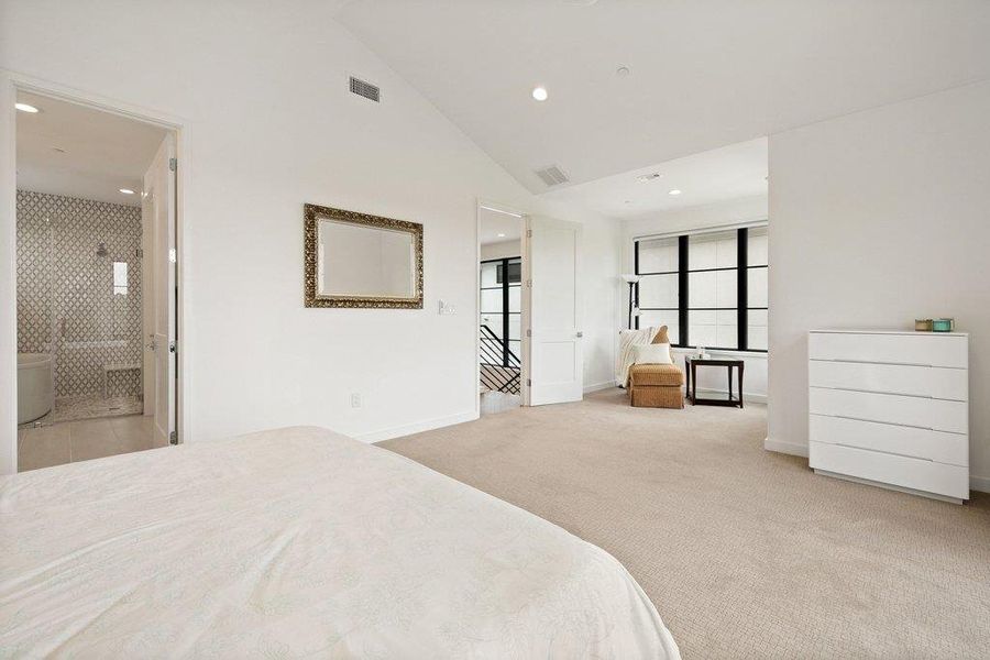 Spacious room with vaulted ceilings and recessed lighting