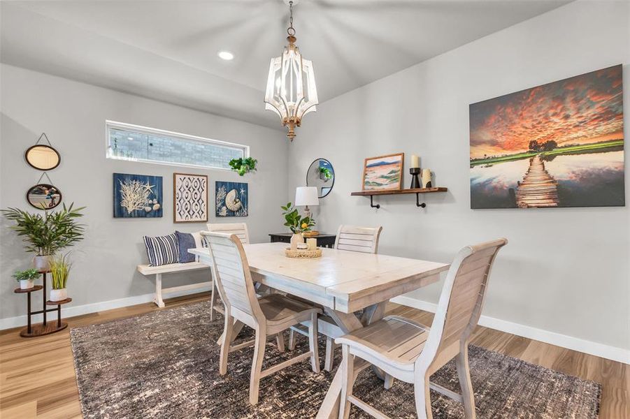 Dining room featuring a chandelier and light wood-type flooring