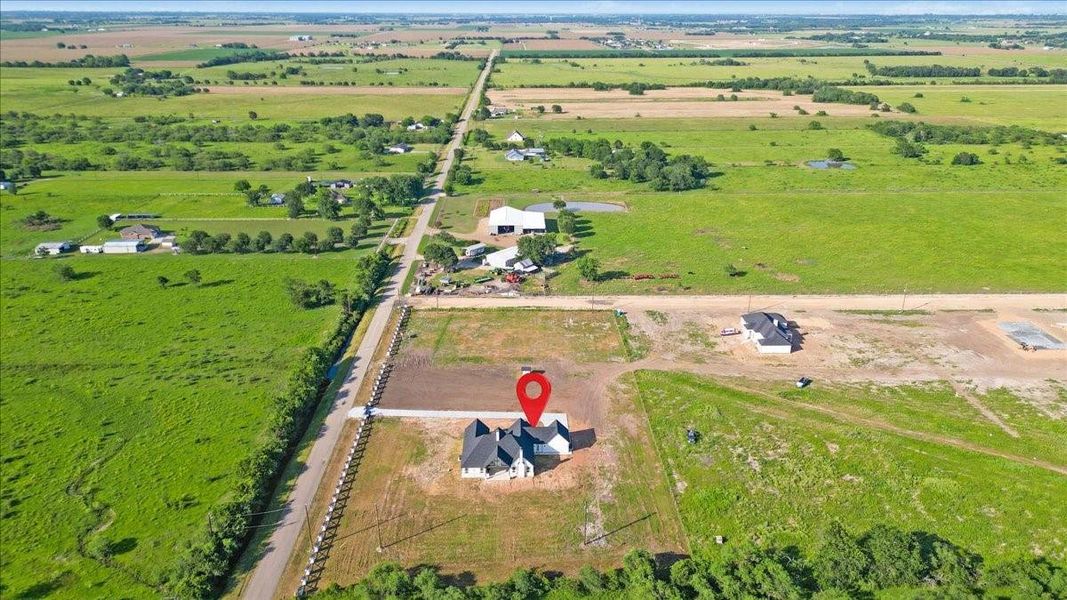 Additional aerial view highlighting the property's generous lot size and open surroundings. Additional aerial view highlighting the property's generous lot size and open surroundings.