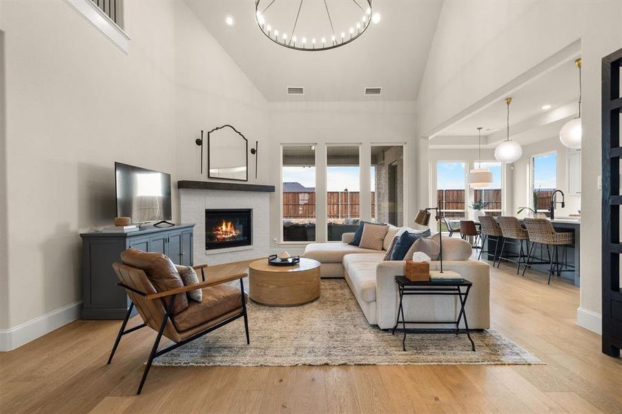 The open floorplan is light and bright, with soaring ceilings and decorative light fixtures throughout.