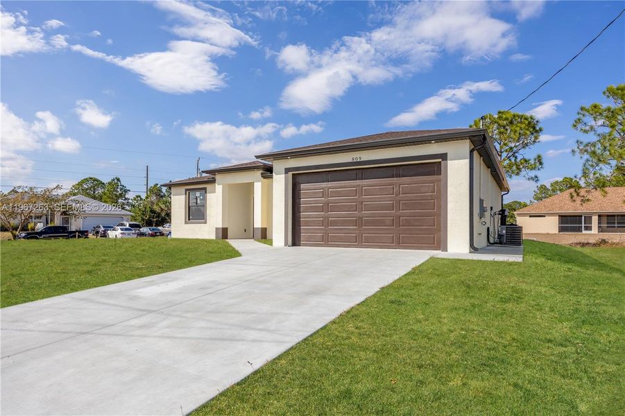 Front exterior of a new home in , Lehigh Acres, FL, highlighting curb appeal (Image 1). Front exterior of a new home in , Lehigh Acres, FL, highlighting curb appeal (Image 1).