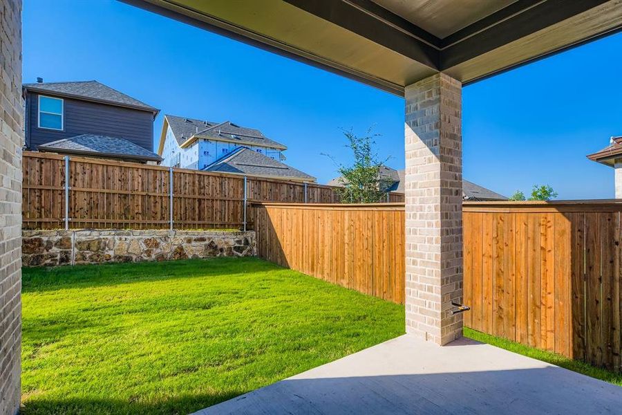 Fenced backyard with a patio area