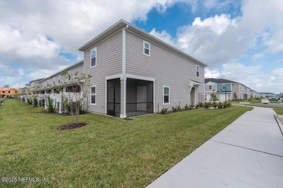 Exterior details and patio area of a home in Hardwick Farms: Hardwick Farms - Townhome Collection, Jacksonville (Image 27).