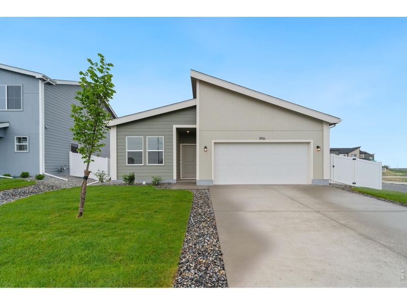 Front exterior of a new home in Liberty Draw, Evans, CO, highlighting curb appeal (Image 1). Front exterior of a new home in Liberty Draw, Evans, CO, highlighting curb appeal (Image 1).