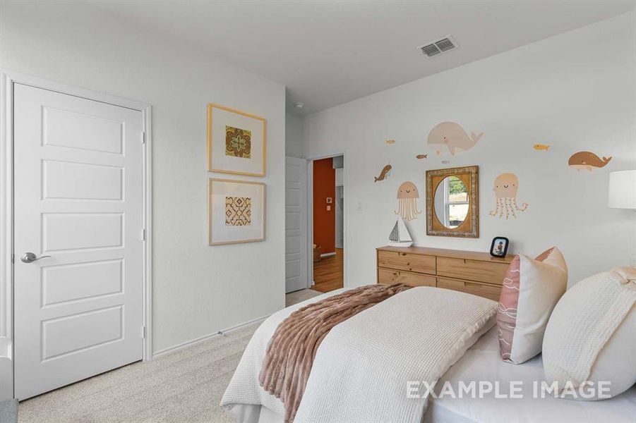 Bedroom with light colored carpet