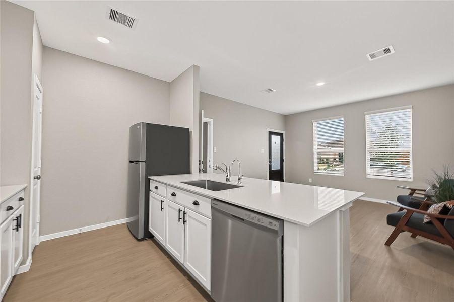 Guest suite kitchen showcasing a spacious island, recessed lighting, and an open layout adjoining the living area. Guest suite kitchen showcasing a spacious island, recessed lighting, and an open layout adjoining the living area.