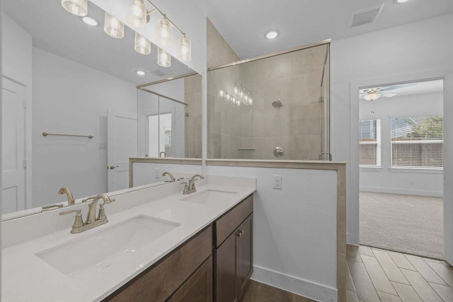 Representative furnished interior of a home built from the Carriagehouse by Chesmar Homes in Meridiana Townhomes, Iowa Colony (Image 53).