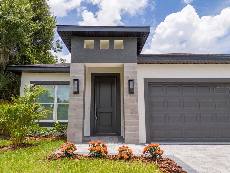 Front exterior of a new home in , Orlando, FL, highlighting curb appeal (Image 24).