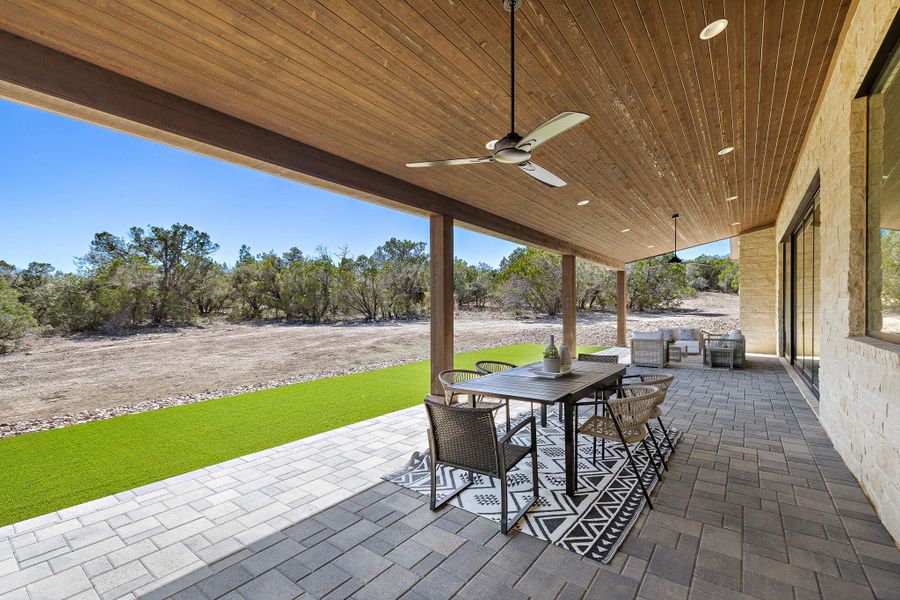 View of patio featuring outdoor dining area and a ceiling fan