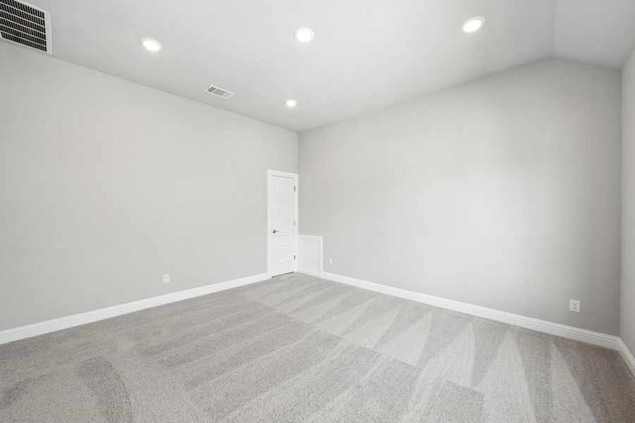 Carpeted empty room featuring recessed lighting and baseboards Carpeted empty room featuring recessed lighting and baseboards