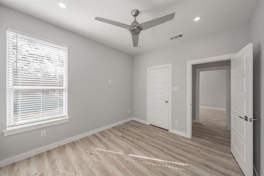 Unfurnished bedroom featuring ceiling fan and light hardwood / wood-style floors