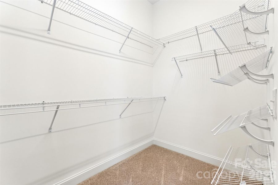 Primary bedroom walk in closet