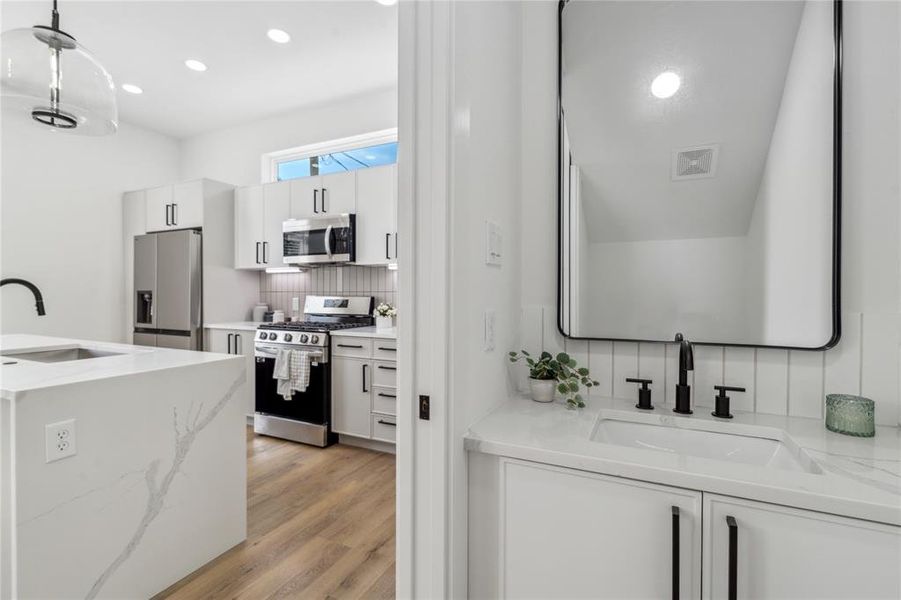 The powder room has a light and bright feel that located to the right between the kitchen and dining.