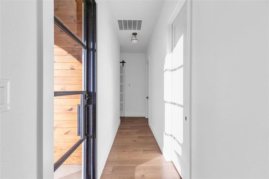 Hallway with iron door to patio