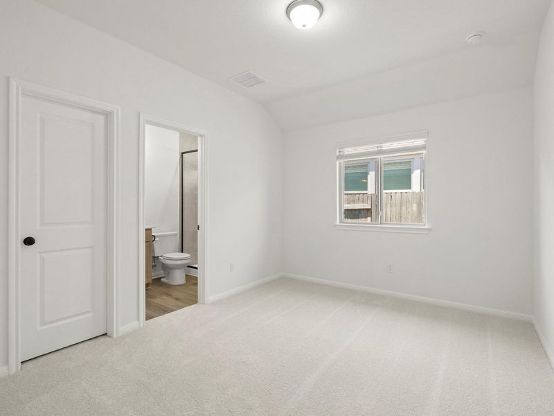 Bright room with light carpeting and a single window