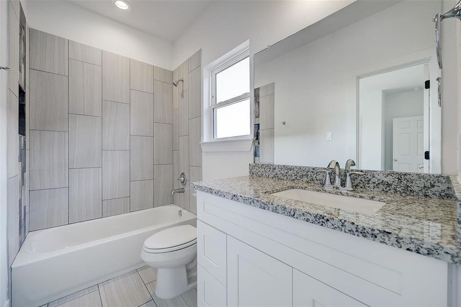 A well-sized jack & jill bathroom joins the secondary bedrooms. Granite tops are complimented by chrome plumbing fixtures