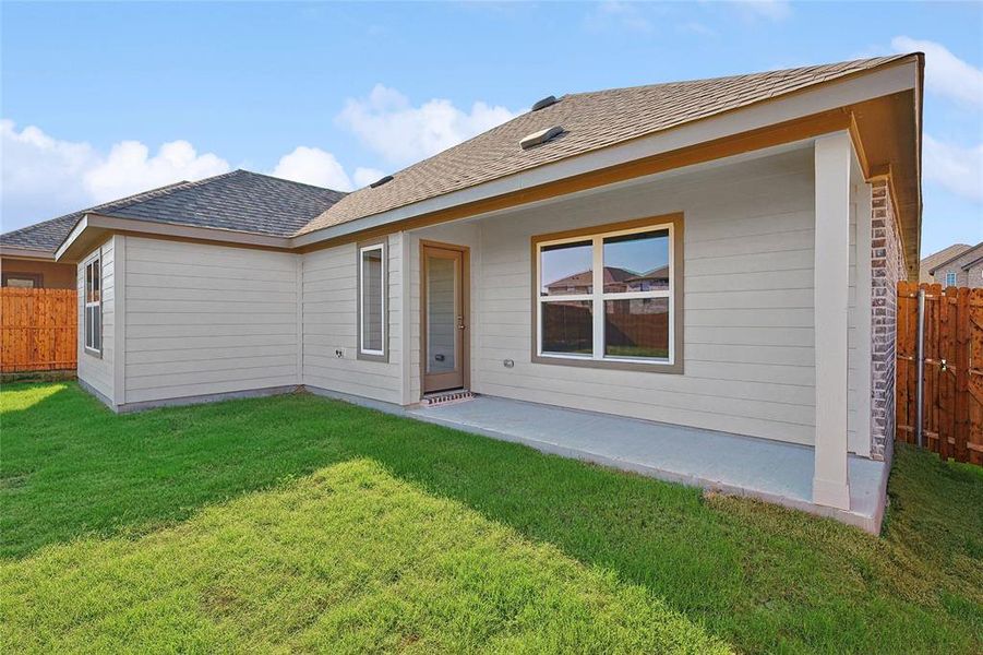 Back of property with a patio and a lawn