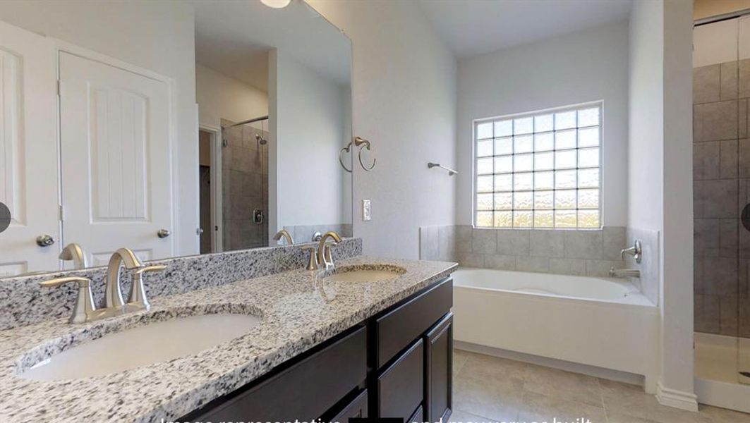 Full bath featuring a shower stall, a garden tub, tile patterned floors, and double vanity