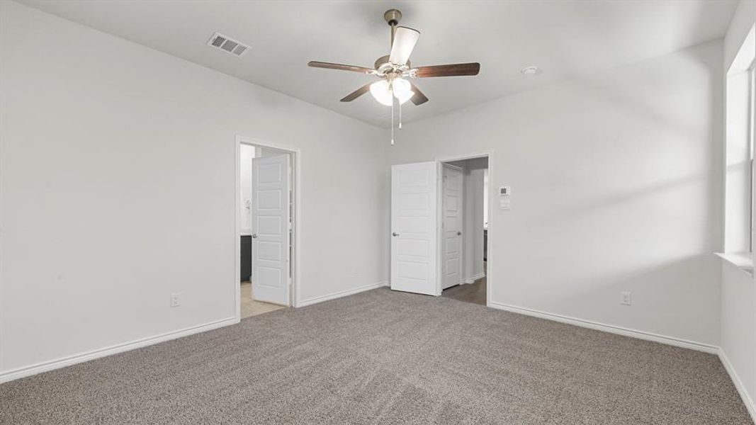 Unfurnished bedroom with carpet floors and a ceiling fan