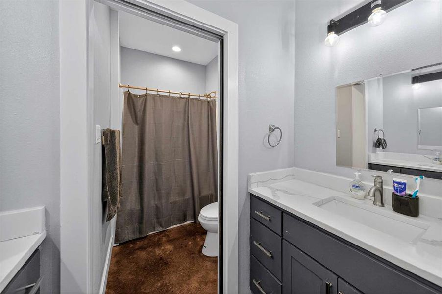 Full bath featuring vanity and concrete flooring Full bath featuring vanity and concrete flooring