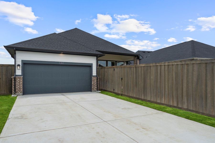 Front exterior of a new home in Riceland, Mont Belvieu, TX, highlighting curb appeal (Image 24).