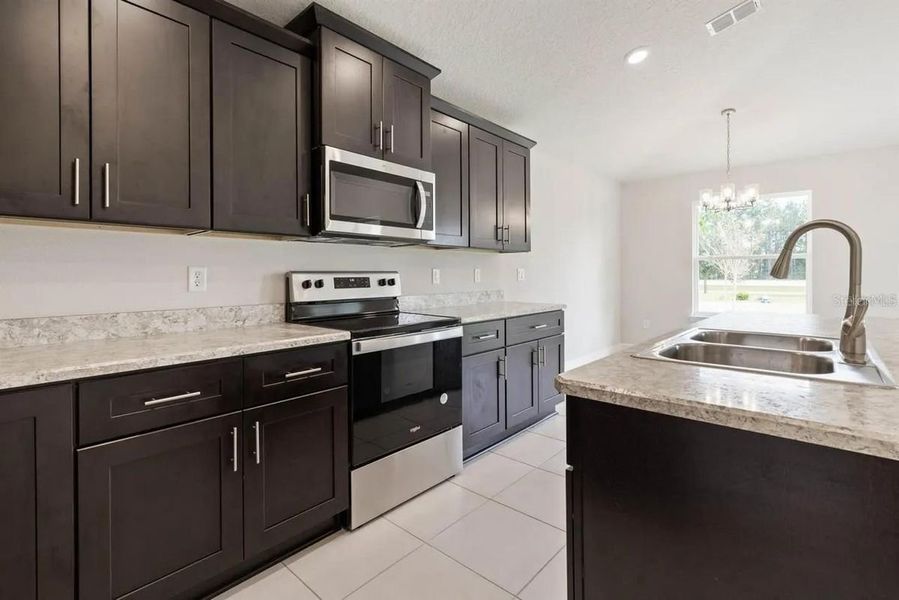 Representative furnished interior of a home built from the 1512 by Adams Homes in Winding Oaks, Weeki Wachee (Image 7).