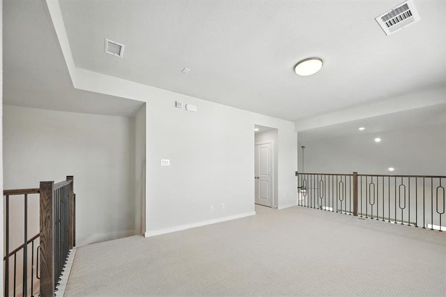 Carpeted spare room with baseboards Carpeted spare room with baseboards