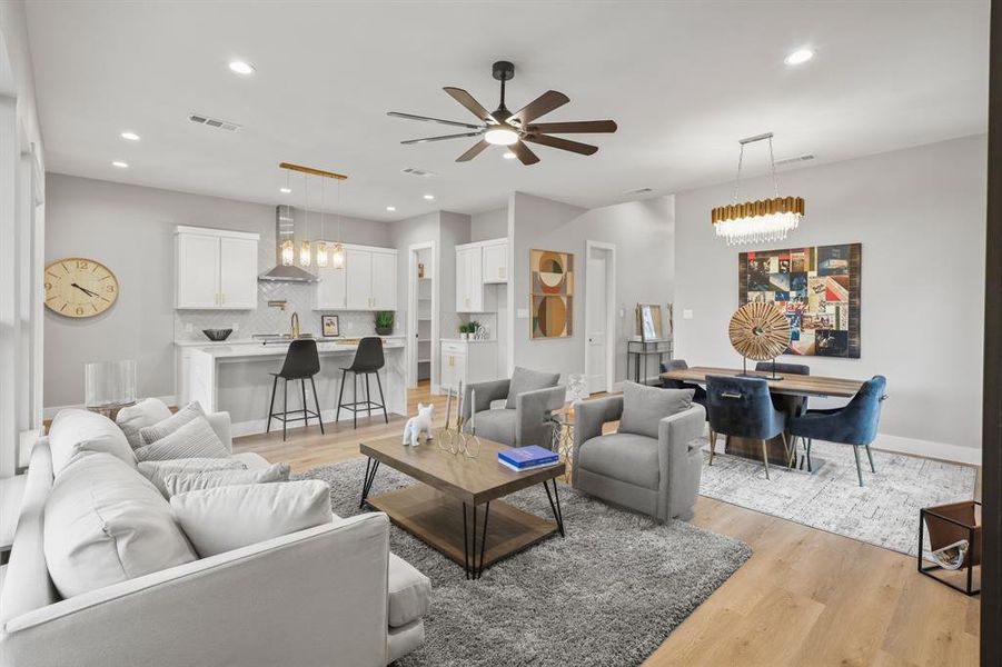 Living room featuring ceiling fan and light hardwood / wood-style flooring