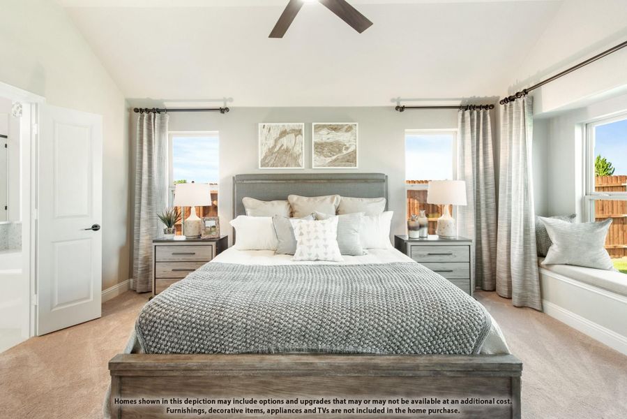 Bedroom with vaulted ceiling, ceiling fan, king bed, two nightstands, and window seat with natural light Bedroom with vaulted ceiling, ceiling fan, king bed, two nightstands, and window seat with natural light