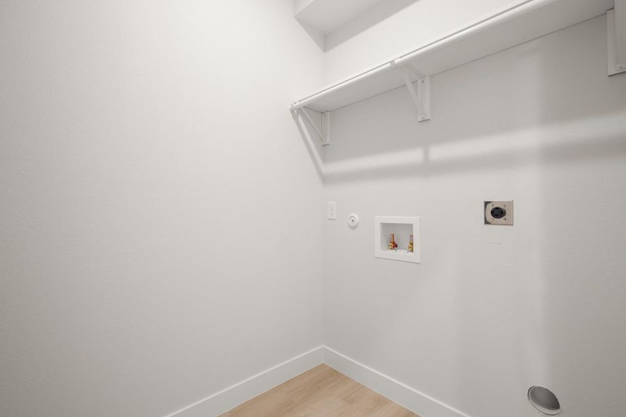 Laundry room with electric dryer hookup, washer hookup, light wood-style floors, and gas dryer hookup