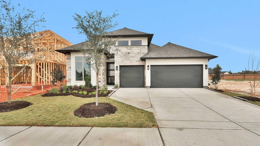 Front exterior of a new home in Elyson 55', Katy, TX, highlighting curb appeal (Image 2).