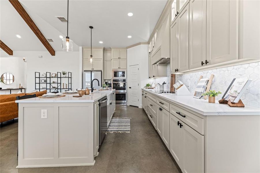 Kitchen with concrete floors, built in microwave, decorative backsplash, freestanding refrigerator, and recessed lighting Kitchen with concrete floors, built in microwave, decorative backsplash, freestanding refrigerator, and recessed lighting