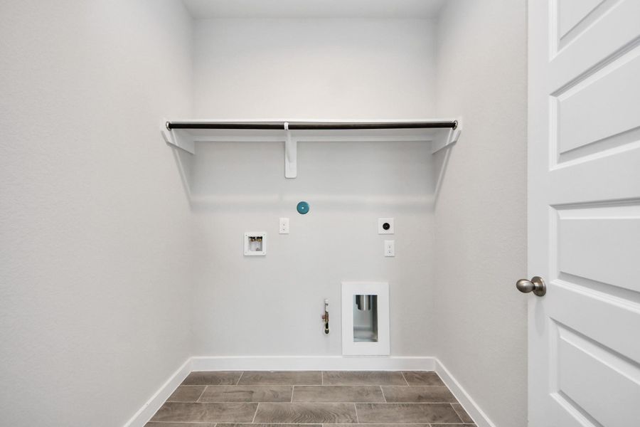 A perfect blend of functionality and comfort. Capture the essence of easy living with a first-floor laundry room, thoughtfully equipped with shelving for effortless organization. Both electric and gas connections available. A perfect blend of functionality and comfort. Capture the essence of easy living with a first-floor laundry room, thoughtfully equipped with shelving for effortless organization. Both electric and gas connections available.