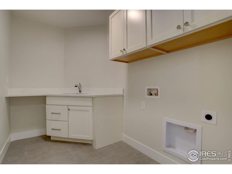 Laundry room on the upper level has everything you need