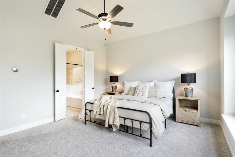 Bedroom with carpet floors, baseboards, connected bathroom, and a ceiling fan Bedroom with carpet floors, baseboards, connected bathroom, and a ceiling fan