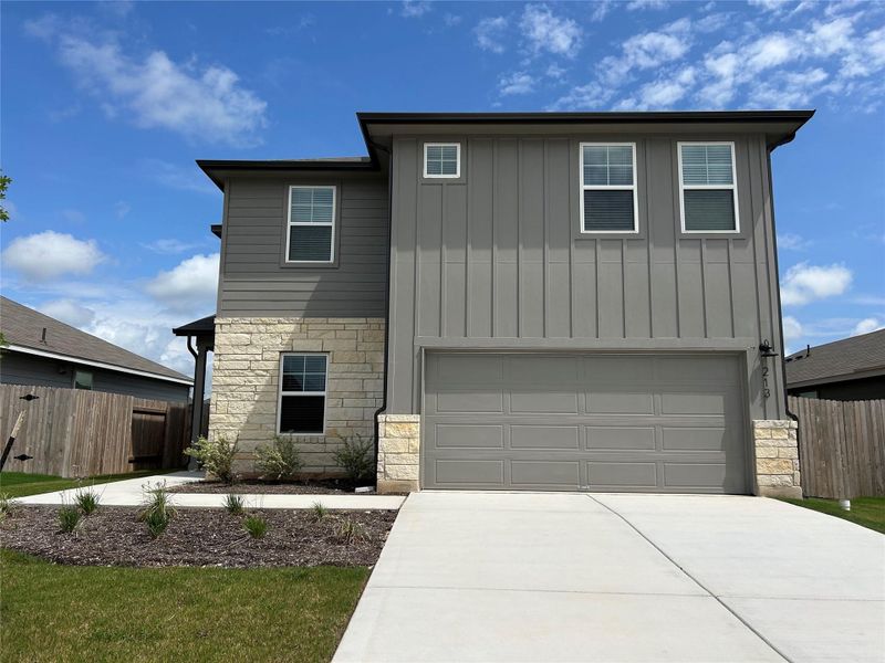 Front exterior of a new home in Eastern Wells, Jarrell, TX, highlighting curb appeal (Image 9). Front exterior of a new home in Eastern Wells, Jarrell, TX, highlighting curb appeal (Image 9).