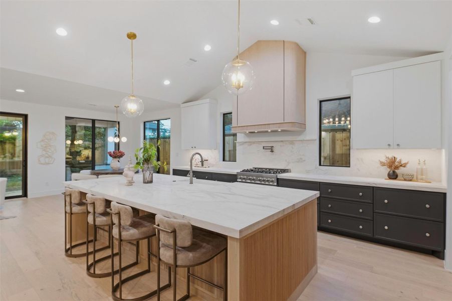 The kitchen island is finished with custom fluted white oak detailing for a beautifully tailored, furniture-inspired look.
